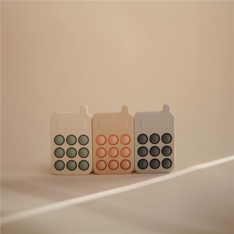 Mushie Sensorik-Spielzeug Telefon, Blush, aus Silikon, BPA-frei